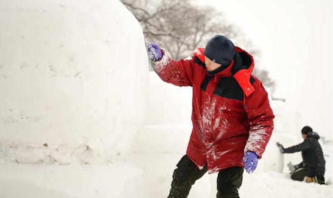 People make snowmen on frozen Songhua River to greet 2019 in Harbin, NE China's Heilongjiang