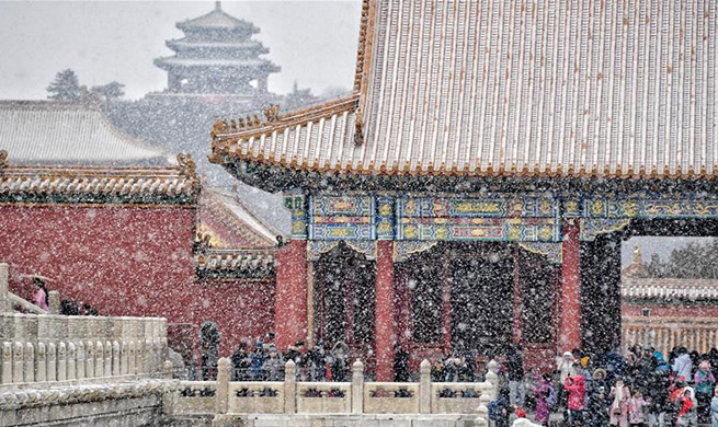 Visitors view snowy scenery at Palace Museum in Beijing